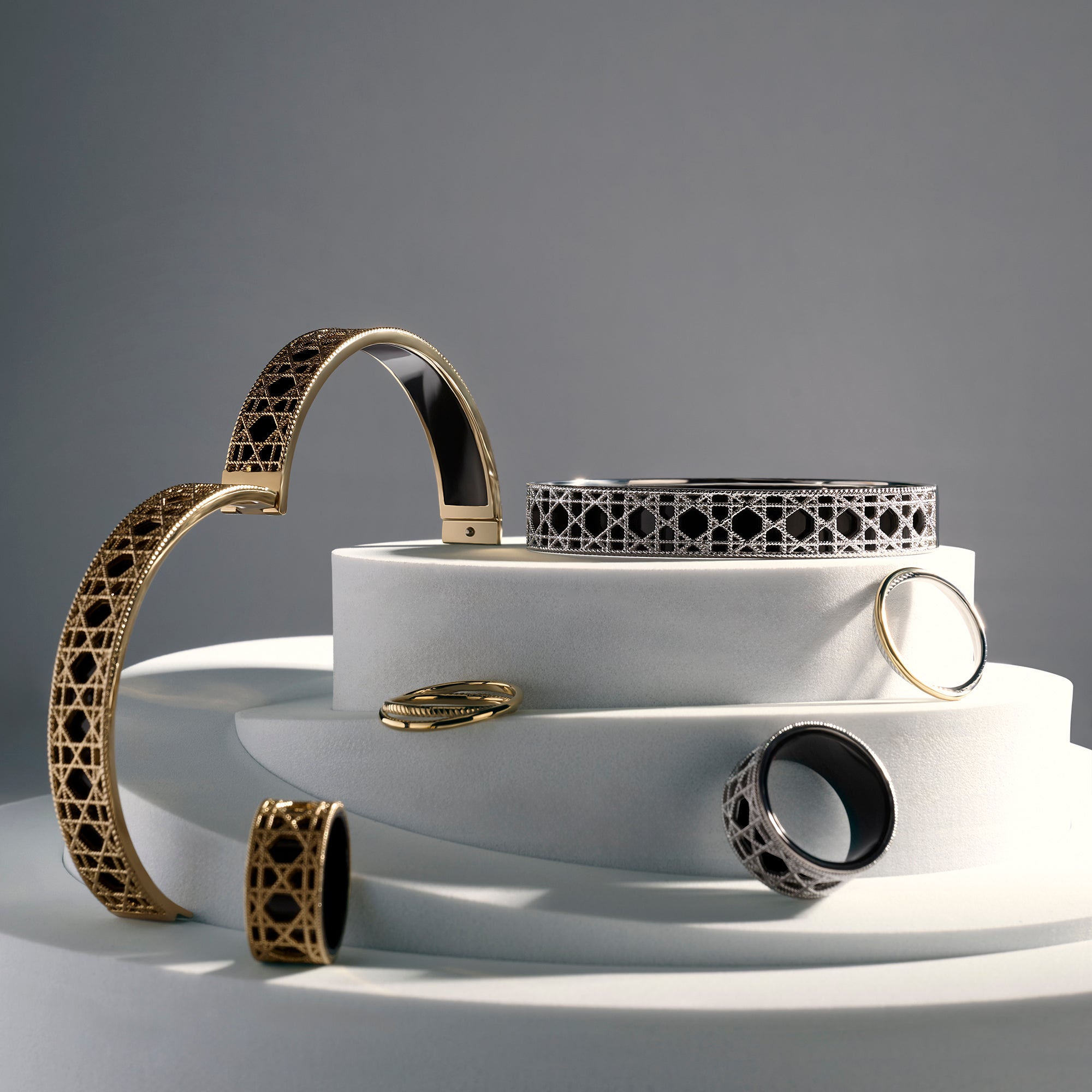 Gold and silver stainless steel openwork jewelry collection with geometric rings and cuff bracelet, bold statement jewelry set with black enamel interior, hypoallergenic non-tarnish durable contemporary jewelry Canada.