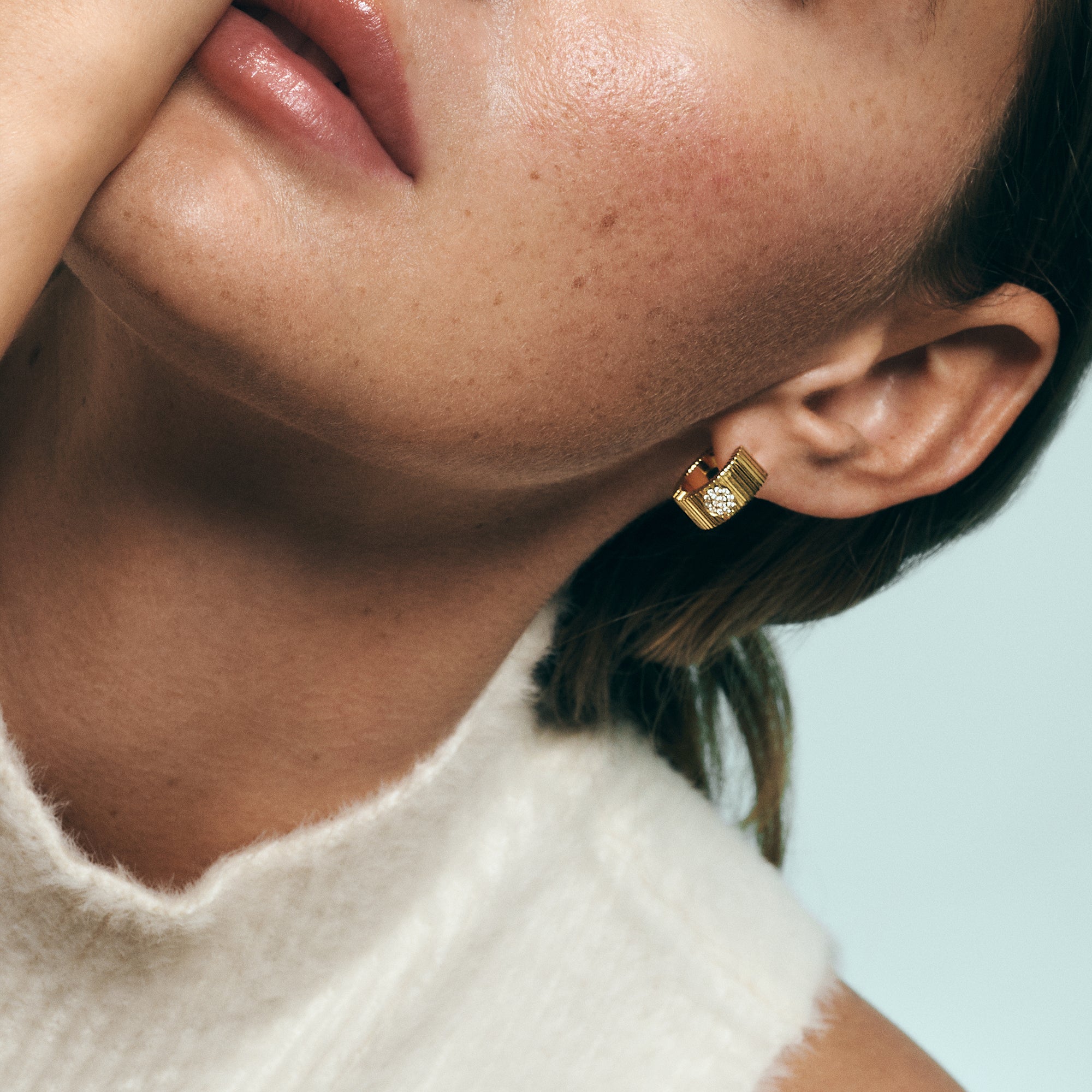 Gold ribbed huggie hoop earrings with pavé detail in stainless steel, bold modern statement earrings, tarnish resistant and hypoallergenic jewelry for sensitive ears in Canada.