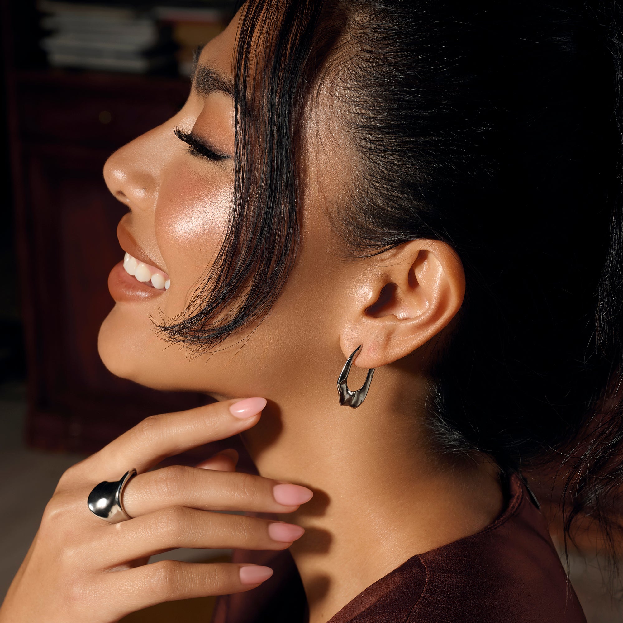 Silver stainless steel sculptural hoop earrings with modern organic shape, hypoallergenic earrings for sensitive ears, non-tarnish durable contemporary statement jewelry Canada.