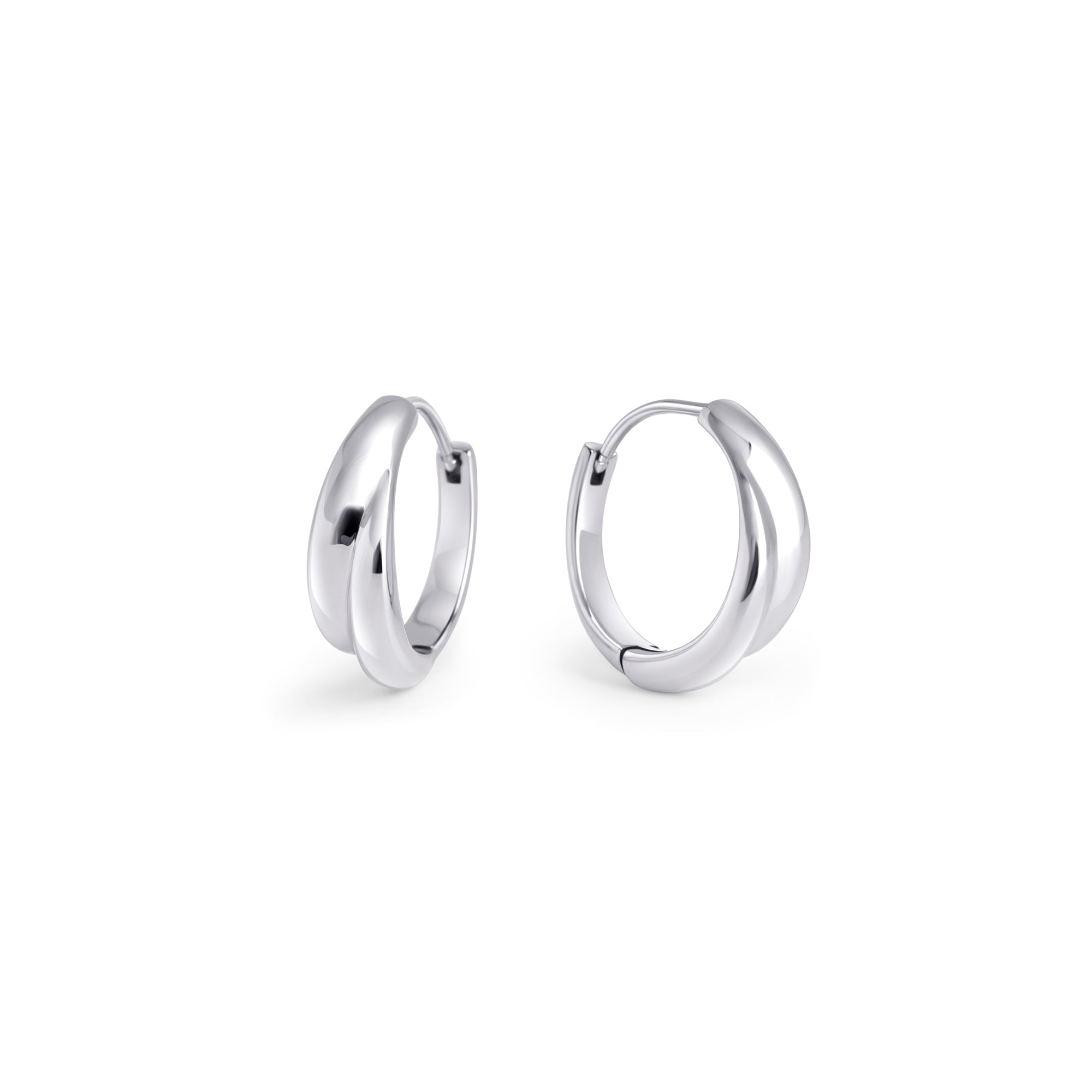 A pair of silver huggie earrings made of surgical stainless steel